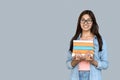 Young adult indian student girl holding books in hands