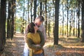 Young adult love couple walking in forest, young family outdoor, husband kiss his wife in hairs