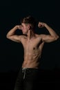 Young adult male flexing his muscles at twilight Royalty Free Stock Photo