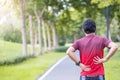 Young adult male with his muscle pain during running. runner man having back body ache due to Piriformis Syndrome, Low Back Pain Royalty Free Stock Photo