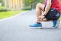 Young adult male with his muscle pain during running. runner man having leg ache due to Ankle Sprains or Achilles Tendonitis.