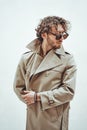 Young adult male model looking suspicious while posing on the white background in a bright studio and wearing cool Royalty Free Stock Photo