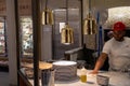 Young adult male standing behind a kitchen counter in a restaurant in New York, United States