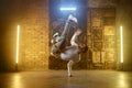 Young adult man breakdancing doing one handed handstand Royalty Free Stock Photo