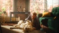 Young Adult Man Having Fun and Playing with His Golden Retriever Pet on a Living Room Floor Royalty Free Stock Photo