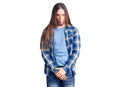 Young adult man with long hair wearing casual shirt making fish face with lips, crazy and comical gesture Royalty Free Stock Photo