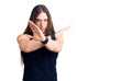Young adult man with long hair wearing goth style with black clothes rejection expression crossing arms doing negative sign, angry