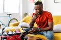 Young adult man packing clothes to the suitcase and writing travel checklist Royalty Free Stock Photo