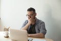 Young adult man reading awful news article in his laptop compute