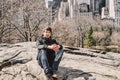 Young adult man sitting in central park new york Royalty Free Stock Photo