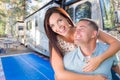 Young Adult Military Couple In Front of Their Beautiful RV At The Campground