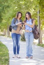 Young Adult Mixed Race Twin Sisters Sharing Cell Phone Experience