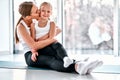 Young adult mother rewards her little daughter with a kiss Royalty Free Stock Photo