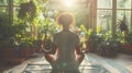 Young adult pregnant black woman practicing yoga at home on mat, African American girl doing hatha yoga asana in modern Royalty Free Stock Photo