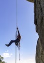 Young adult rock climber rappelling a granite wall in Torrelodones, Madrid. Extreme sports Royalty Free Stock Photo