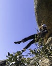 Young adult rock climber rappelling a granite wall in Torrelodones, Madrid. Extreme sports Royalty Free Stock Photo