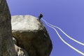 Young adult rock climber rappelling a granite wall in Torrelodones, Madrid. Extreme sports Royalty Free Stock Photo