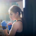 Young adult boxing girl posing with gloves.