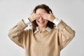 Young happy woman covering closing eyes with hands at white background. Royalty Free Stock Photo