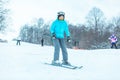 young adult smiling woman skiing down by hill Royalty Free Stock Photo