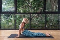 Young adult sporty girl practicing yoga in gym club Royalty Free Stock Photo