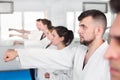 Young adult trainees practicing in karate class