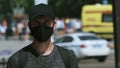 Undercover police provocateur agent in covid-19 face mask among rally crowd.
