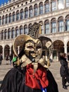 Young adult in wearing a black and red festive costume during the Carnival of Venice