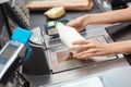 Young adult woman cashier checking price on checkout Royalty Free Stock Photo