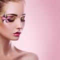 Young adult woman with closed eyes and creative makeup on pink b Royalty Free Stock Photo