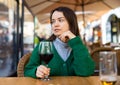 Young adult woman drinking wine at restaurant Royalty Free Stock Photo