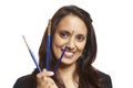Young adult woman face painter with paint brushes Royalty Free Stock Photo