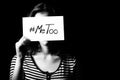 Young adult woman holding a sign with the hashtag MeToo