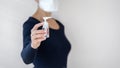 Young adult woman holding dispenser bottle with cleanly sanitizer gel