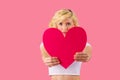 Young adult woman holding pink heart, romantic love Royalty Free Stock Photo