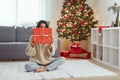 Woman With Present in the Gift Box Near Christmas Tree at Home Royalty Free Stock Photo