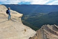 Young adult woman looking at the landscape from  Lincoln Rock Lookout at sunset of the Grose Valley located within the Blue Royalty Free Stock Photo