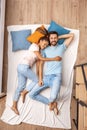 Young adult woman and man lying on bed together Royalty Free Stock Photo