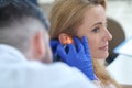 Young adult woman and otolaryngologist examining ear Royalty Free Stock Photo