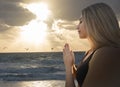 Young Adult Woman Relaxed Prayer Pose at Beach - Seagulls Orange Sunlight Sky Clouds Parting - Visual Meditation Yoga Zen -