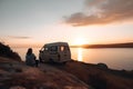 young adult woman sits on a hill above the sea next to her travel minivan vehicle at sunset, neural network generated