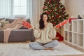 Woman Holding Gift Boxes with Presents at Home Near Christmas Tree Royalty Free Stock Photo