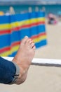 Young adult woman stretching legs on barrier at beach Royalty Free Stock Photo