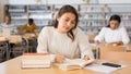 Young adult woman studying in public library Royalty Free Stock Photo