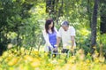 a young adult woman supporting a senior man using a walker to walk in the park Royalty Free Stock Photo