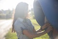 young adult woman talking on a public street phone on the street in a Russian village in the sun Royalty Free Stock Photo