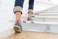 Young adult woman walking up the stairs Royalty Free Stock Photo