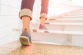 Young adult woman walking up the stairs with sun sport background Royalty Free Stock Photo