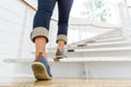 Young adult woman walking up the stairs