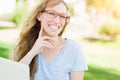 Professional Young Adult Woman Wearing Glasses Outdoors Using Her Laptop. Royalty Free Stock Photo